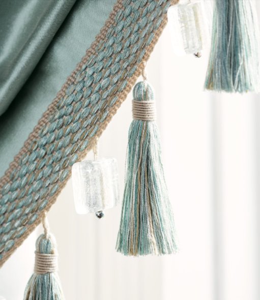 Tasselled passementerie trim on velvet drapery, with glass bead accents