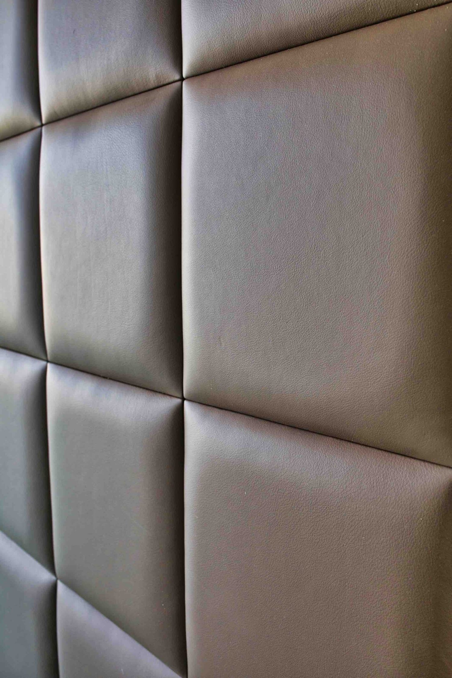 Bespoke padded leather wall paneling in square panels