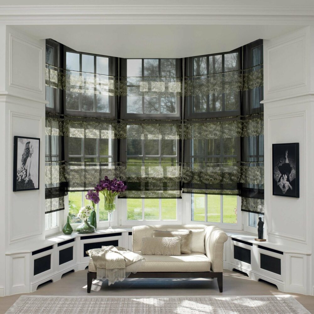Classical bay window with bespoke roman blinds in semi-transparent fabric