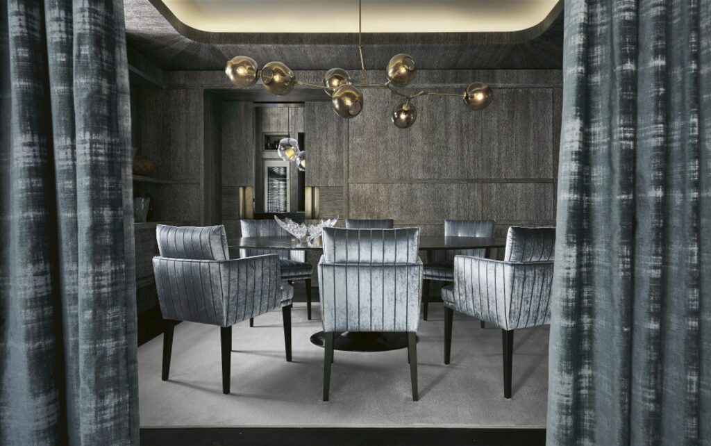 Private dining room with grey velvet chairs and bespoke curtains