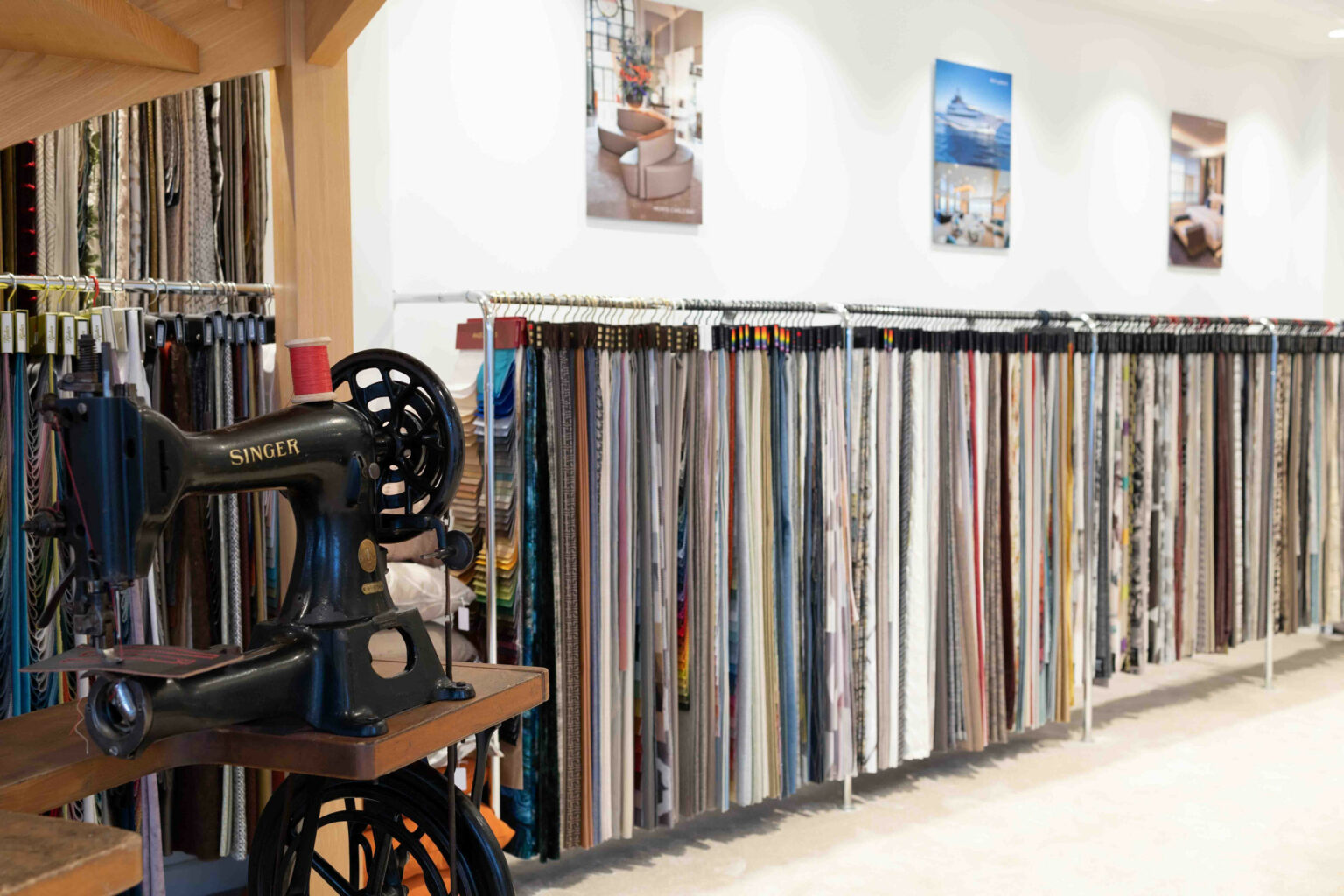 Singer sewing machine in the showroom — fabrics on display