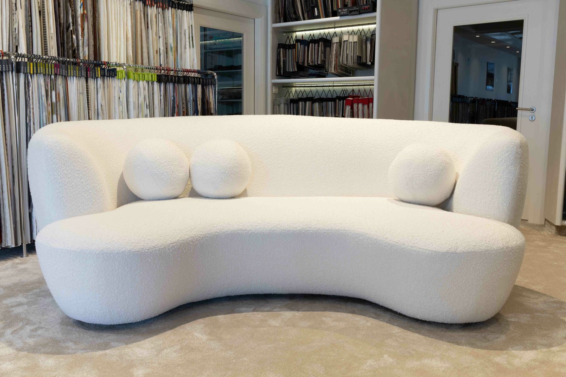 Bespoke curved sofa upholstered in ivory bouclé, Funfrock showroom