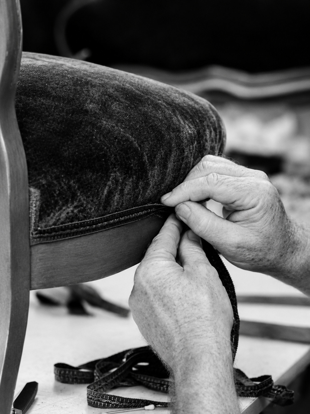 Upholsterer's hands at work on fabric